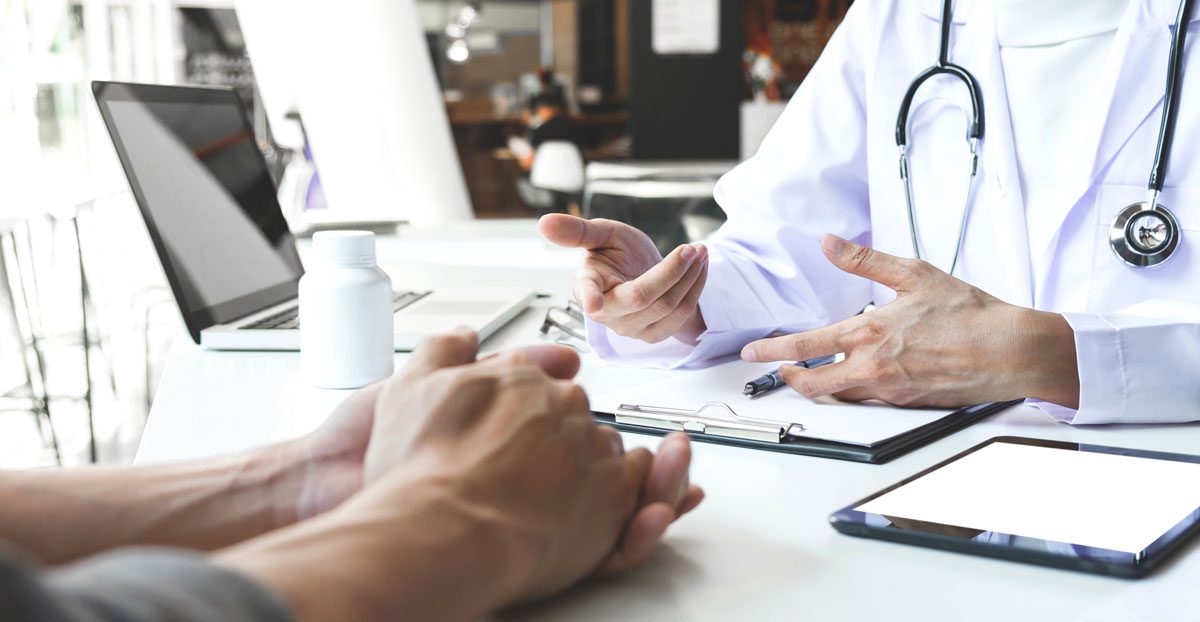 Doctor-discussing-treatment-with-patient Doctor-discussing-treatment-with-patient